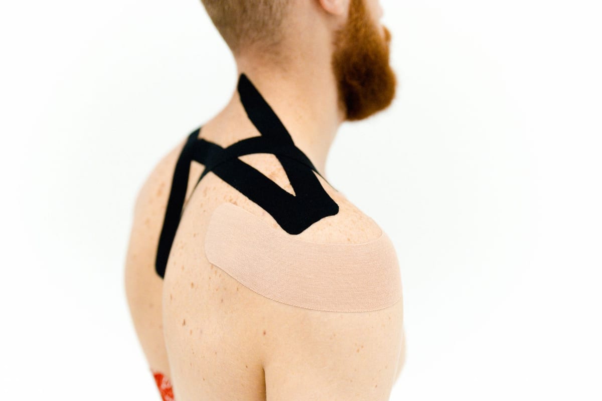 Kinesiology tape applied across a shoulder